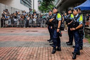 Police officers stand near the media area outside the West