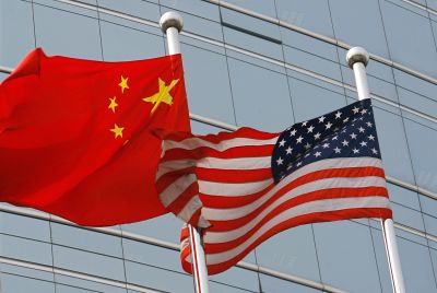 A US and a Chinese flag wave outside a commercial