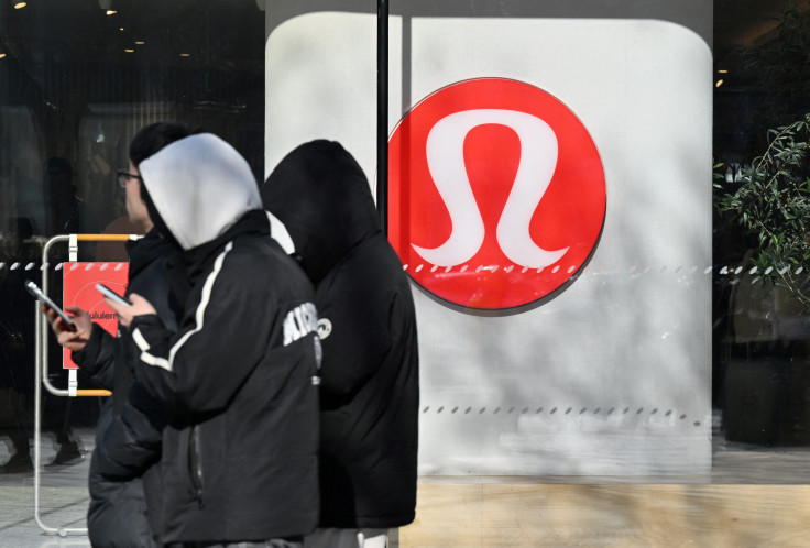 People walk past a Lululemon store, a Canadian brand, in