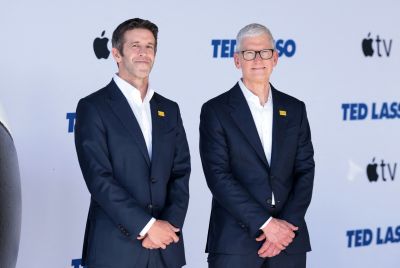 Tim Cook (R), CEO of Apple, walks with John Ternus,