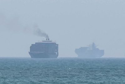cargo ships anchoring near the Strait of Hormuz