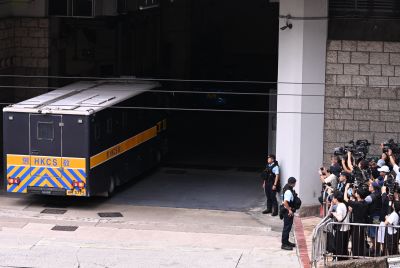 A prison van (L) purported to be holding pro-democracy activist