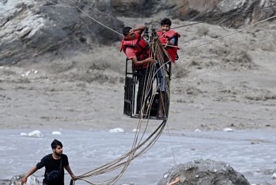 Residents commute across the Trishuli river via a newly installed