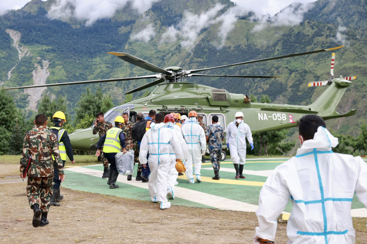 A Nepal Army helicopter carries dead bodies from the flood