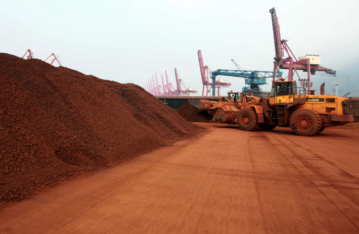 a man driving a front loader shifts soil containing rare